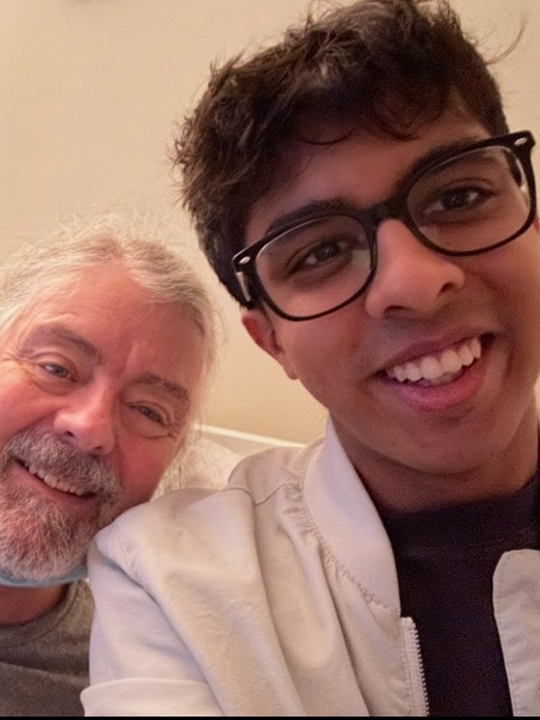 Rishi taking a selfie with an older man, both smiling