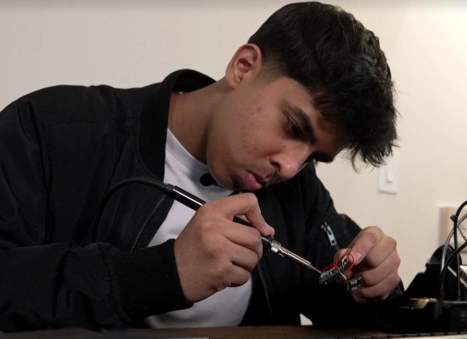 Rishi soldering a circuit board